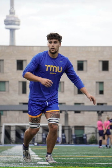 Evan Dermott on a rugby field
